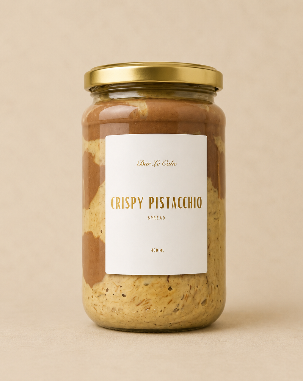 Jar of 'Crispy Pistacchio' spread with a gold lid on a beige background